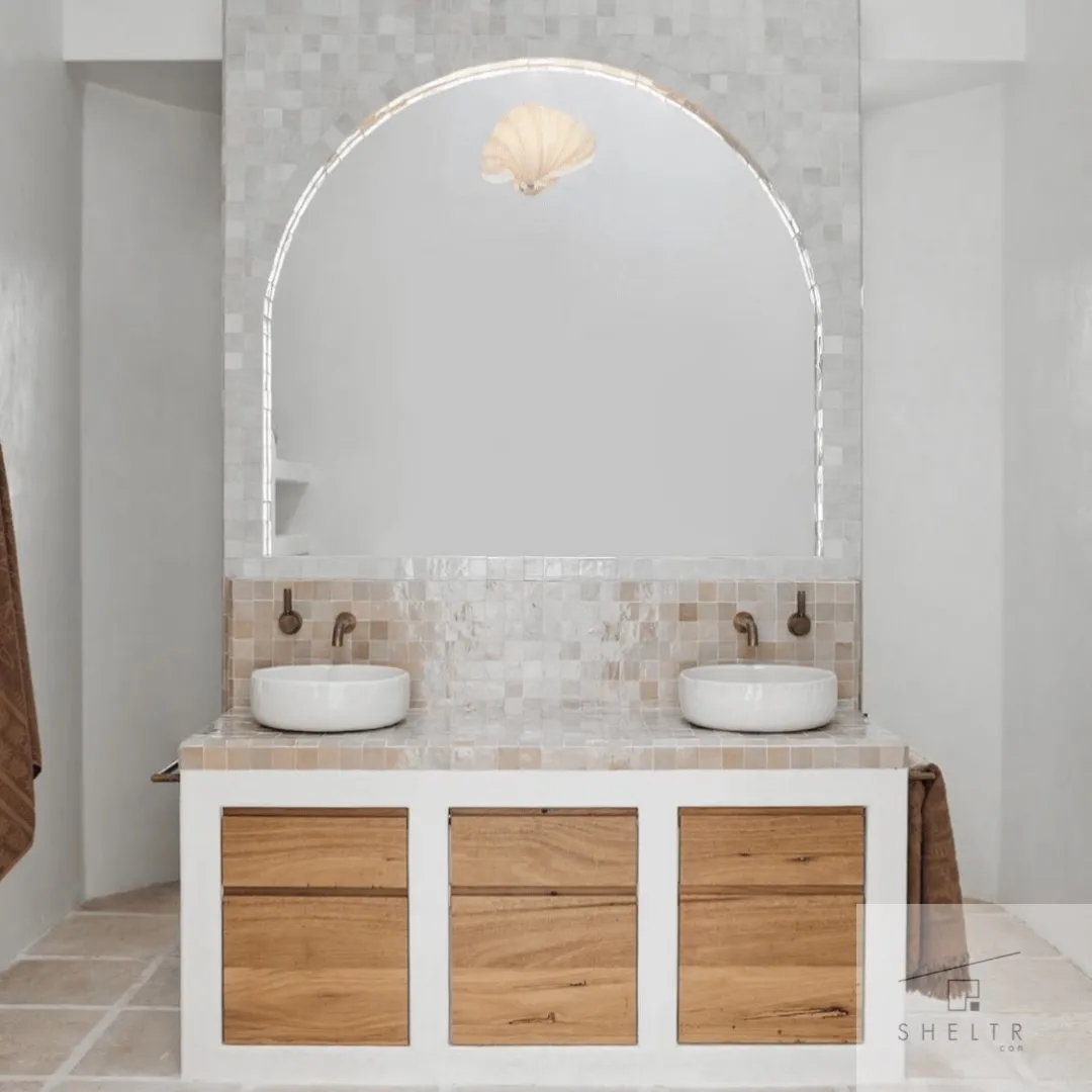 Modern double sink vanity with wooden drawers and arched mirror.