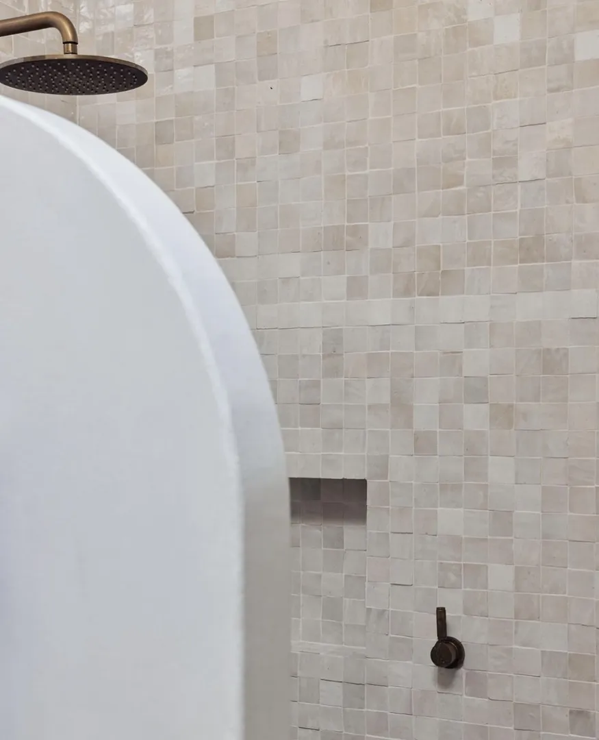 Modern tiled shower with brass fixture